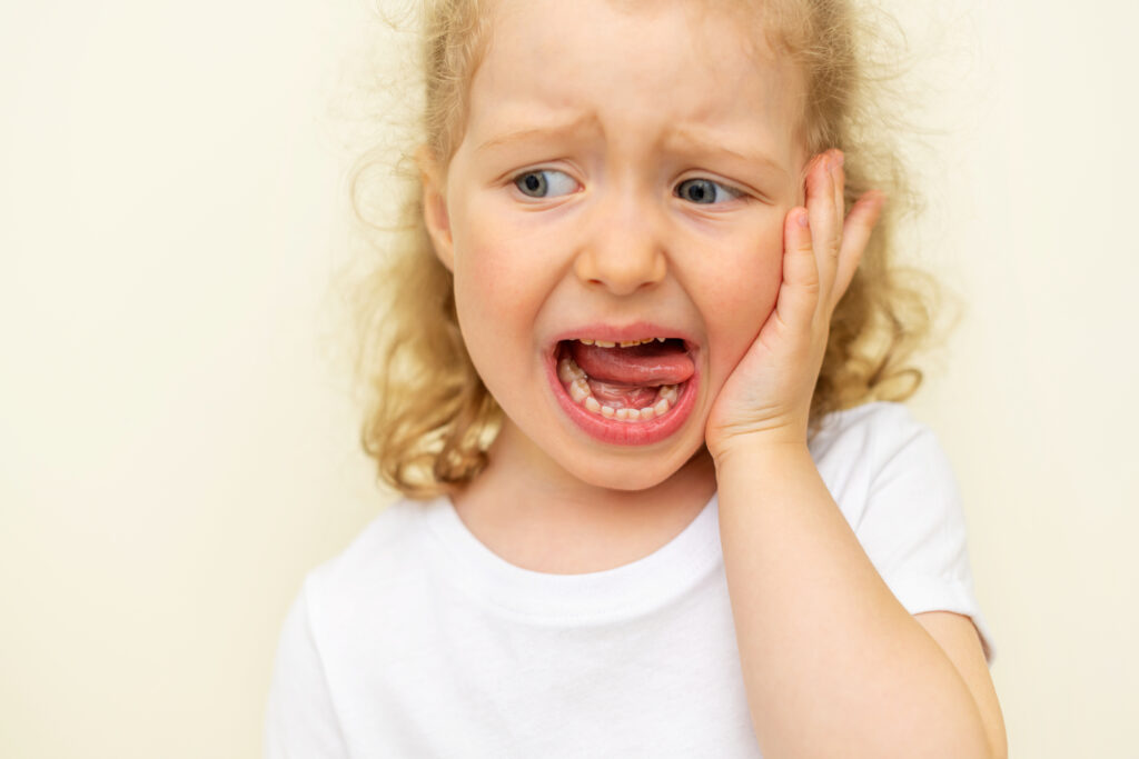 The child has a toothache. Children's caries in the initial stage.